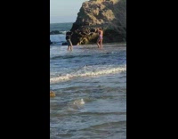 Purple bikini girl beach water grey rock 