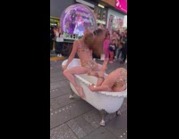 Two ladies dance at bathtub in new times square 