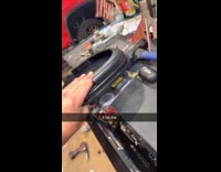 Mans thumb caught between magnet and metal