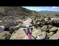 Guy rides orange bicycle wood bridge mountain