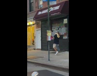 Guy walks with yellow snake on his shoulders 