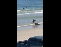 Woman black swimsuit bend body beach seaside