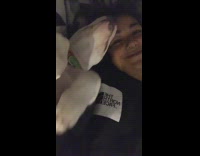 Girl lays back black white dog bed 