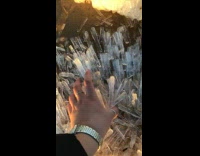 Woman grab ice shards on the beach