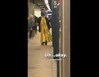 Guy at subway station wears gold cape
