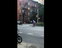 Grandma blue dress ride scooter on street