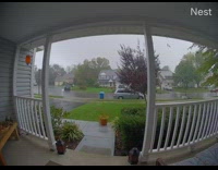 Wind blows brown bag blue trash can