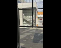 Four people selfie staircase window red car 