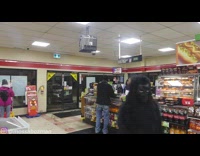 Guy black gorilla suit walks through convenience store Mossabozma