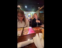 Woman eats cucumber with dressing at restaurant