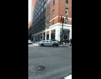 Police officers approach two cars crash street