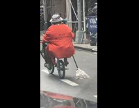 Man wear state penitentiary shirt ride bike