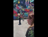 Woman in tiktok dance in front of the wall with graffiti