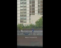 Guy practices his lasso skills on a fake horse on rooftop