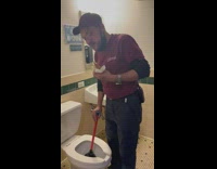 Employee cleans toilet while eating 