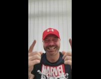 Laughing guy covers mouth and points up