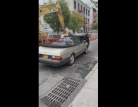Guy drives convertible car with hood open 