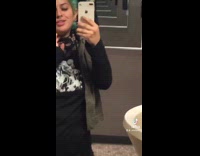 Girl green hair records herself in mirror 