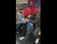 Spiderman hanging upside down on subway train