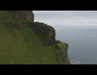 Drone shot mountain cliff Iceland beach cave
