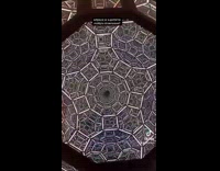 Guy looks at art sculpture in museum 