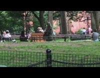 Guy in swamp costume approaches people at park 