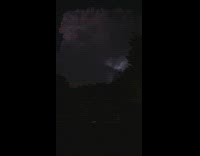 Lighting strikes behind the dark clouds in the sky