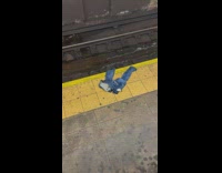 Discarded jeans at subway station platform with brown stains