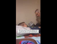 Mother films wholesome moment of herself putting makeup on son