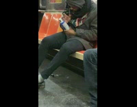 Guy sucks air out of canned air duster on subway train