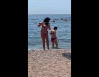 Woman in bikini selfie photoshoot at beach