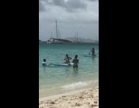 Woman onesie swimsuit sit on paddle board part 3