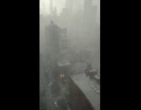 Filmer on building show rain and wind