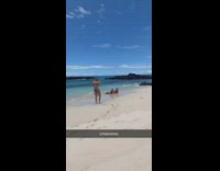 Guys pose on beach shore 