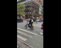 Man singing karaoke on electric bike parked in street