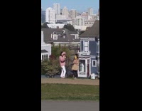 girl takes picture full house home flowers