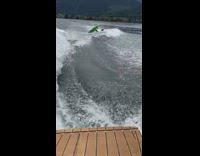 Black wetsuit green wakeboard guy wave fail 