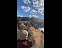 Woman blue sports bra bridge beach rocks