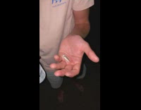 Guy pops a small fish in his mouth 