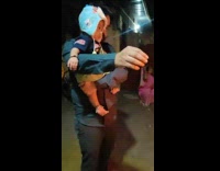 Man carries a baby and lights up the firecracker