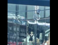 Woman black dress twerk building window bulb