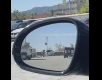 Two girls parking lot car mirror