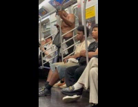 Submitter shows shirtless man standing on train 