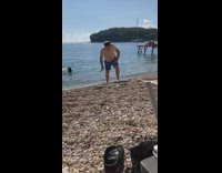 Man struggles to walk on beach full of rocks