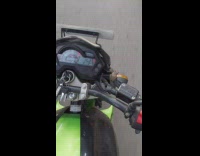 Guy rides green scooter with brown toad 