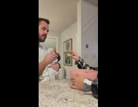 Dad feeds baby while big sister feeds him