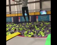 Guy does backflip off off trampoline and lands in foam pit