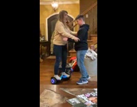 Woman cannot balance on hoverboard and falls over