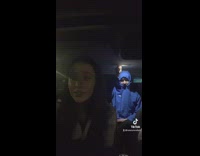 Girl and guy sing in car 