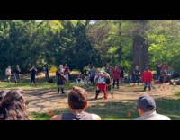 People watch medieval armor duel match at park